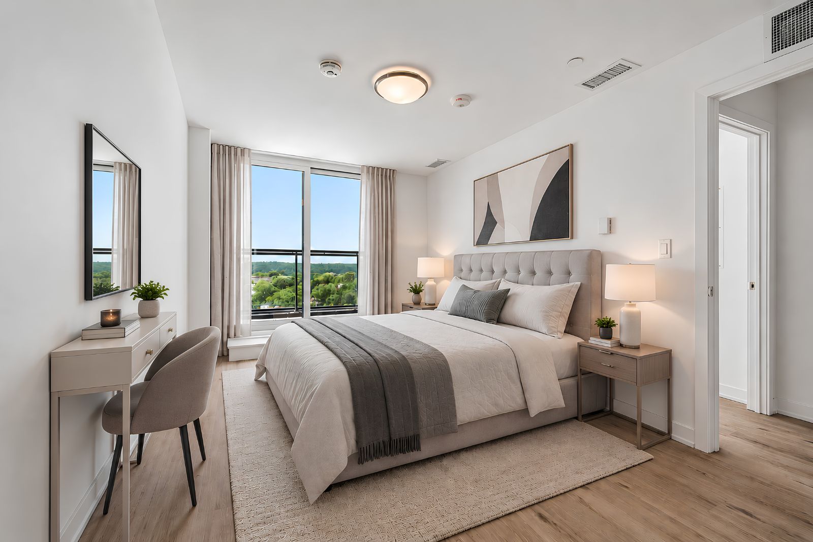 Bedroom with balcony in a finished East Pointe suite, virtually staged
